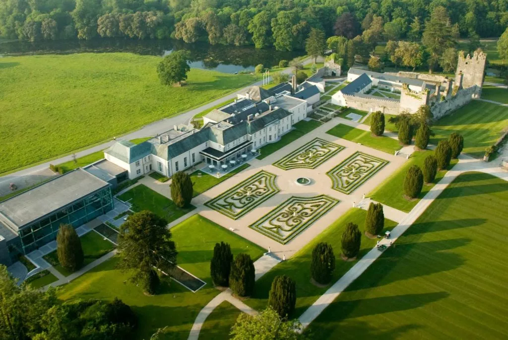 Arial photo of Castlemartyr Resort showing the gardens, the river, and some woods.